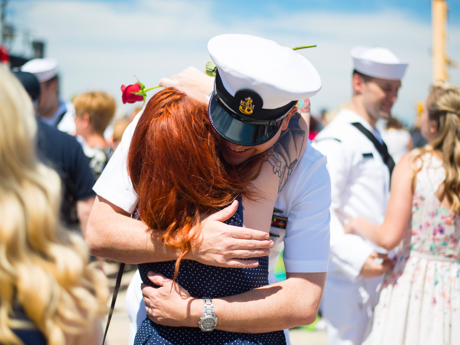 Navy sailor hugging woman